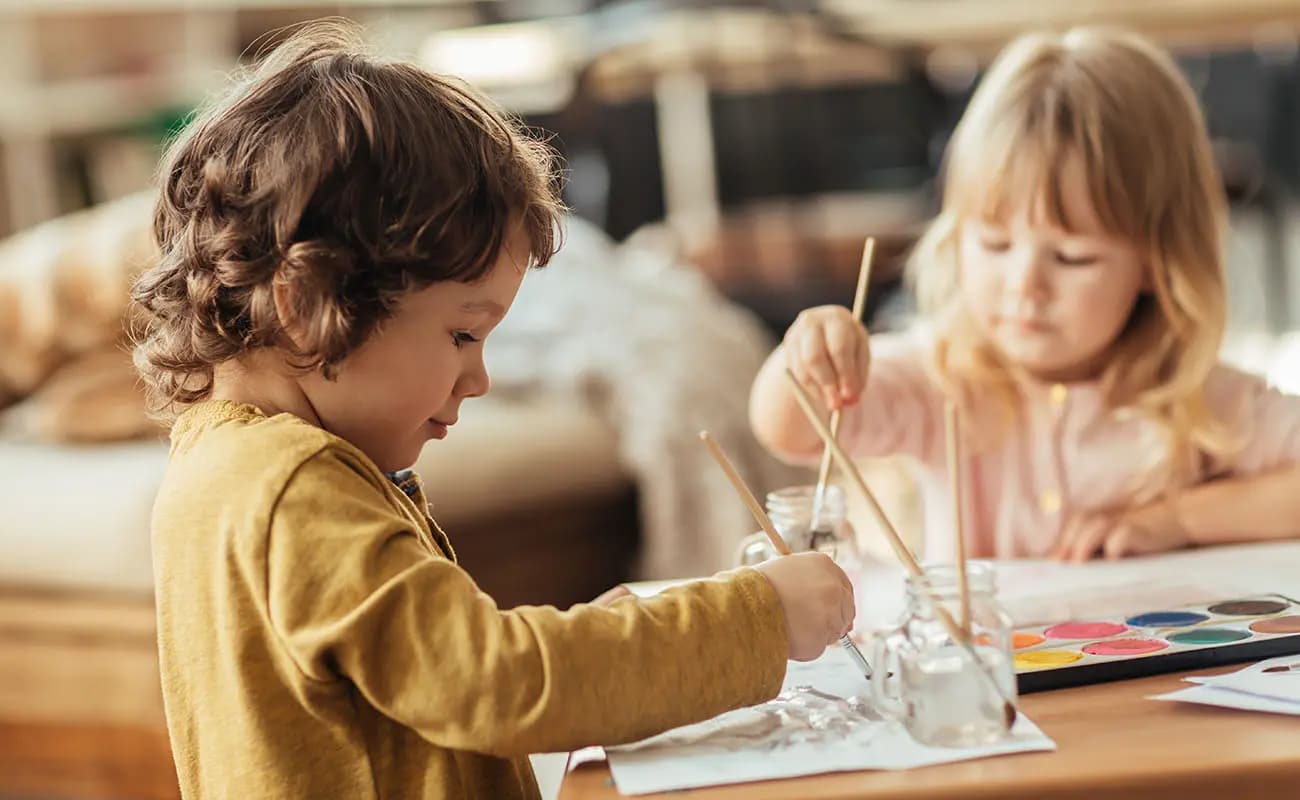 Children painting and creating at a table